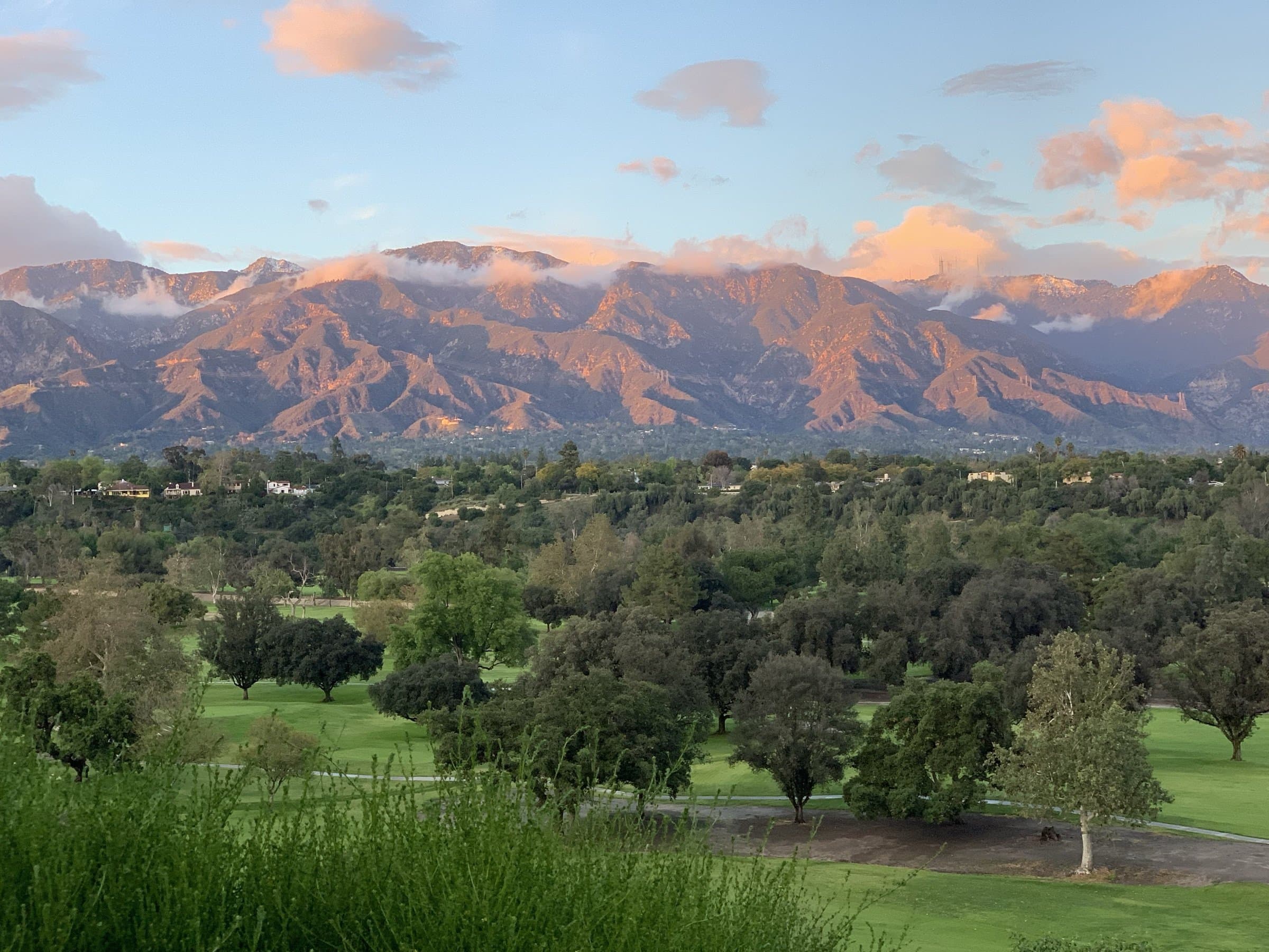 Brookside Golf Course and the Linda Vista hillside beneath the San Gabriel Mountains at sunset.